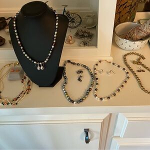 Lot of pearl necklaces with earrings.